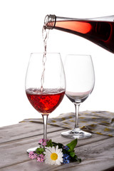 Rose wine served with two glasses and flowers copy space close up