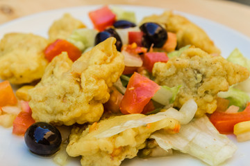 Marinated dogfish with corn, olives, lettuce, oil and salt. food for summer