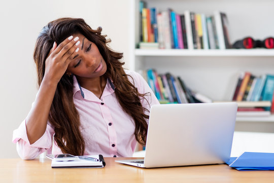 Stressed african american woman at computer