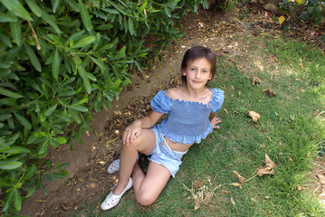 Girl sits on a grass
