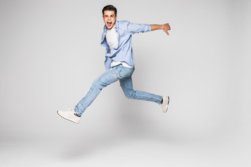 Fototapeta na wymiar Handsome young man jumping isolated on white background