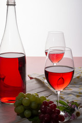 Rose wine served with two glasses and flowers copy space close up