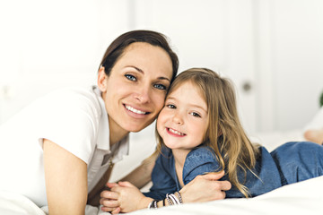 Mother with daughter on bed