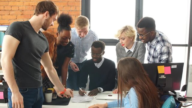Multiracial contemporary business people in working process in modern studio.