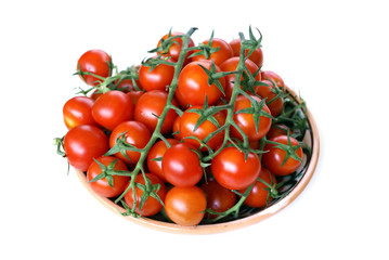 Twigs of cherry tomatoes lie on a plate
