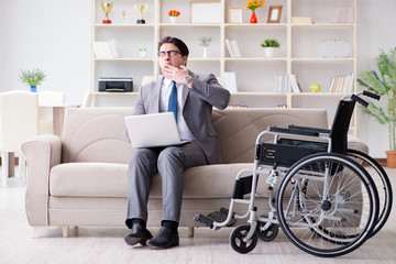 Dsabled businessman on wheelchair working home