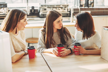 Friends trying to cheer up young depressed woman