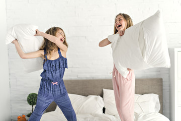 Obraz na płótnie Canvas Portrait of two girls child friend in bed wearing pajamas