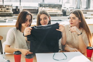 Friends unpacking new clothes. Shopping day