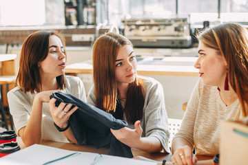 Friends discussing new purchases. Shopping day