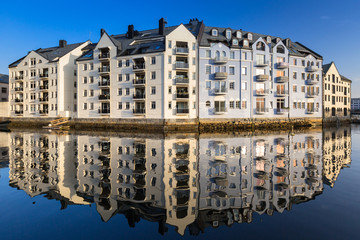 Fototapeta na wymiar Architecture of Alesund town reflected in the marina canal, Norway