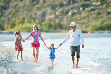family with children at summer vacations on sea beach