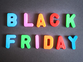 colorful lettering of black friday on a black background.