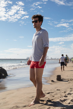 Young man at the on sea shore in swimwear