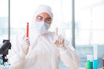 Man doctor checking blood samples in lab