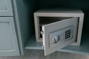 Open safe in a wealthy house. Safety box in hotel room. Concept safe storage of money and documents