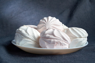 White zephyr marshmallow on porcelain plate