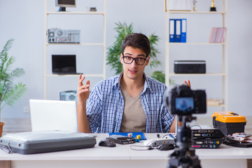 Vlogger recording computer repair on camera for vlog blog
