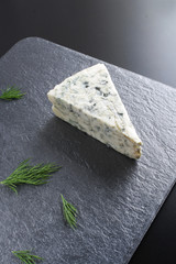 blue cheeseon a dark stone background