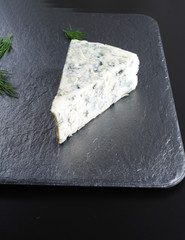 blue cheeseon a dark stone background