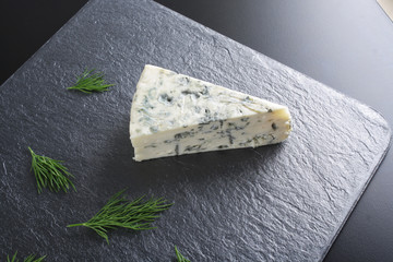 blue cheeseon a dark stone background