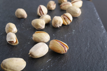 pistachioson a dark stone background