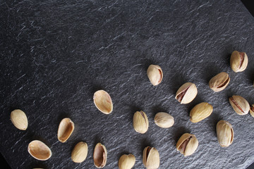 pistachioson a dark stone background