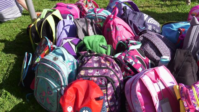 kids school backpacks leaning against one another