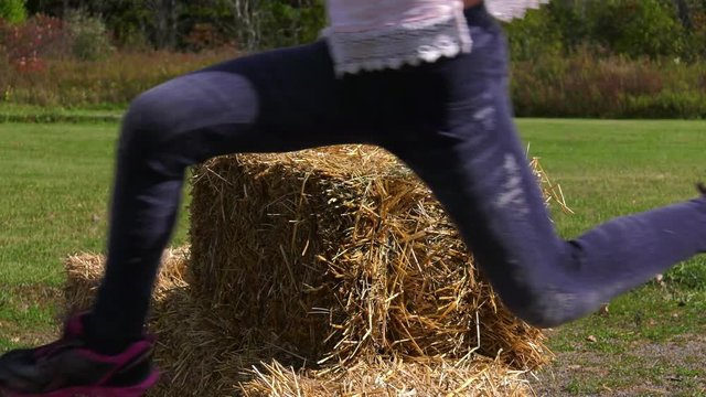 kids jump over bale of hay obstacle course slow motion 4k 60fps