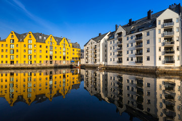 Architecture of Alesund town reflected in the water, Norway