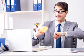 Businessman looking after newborn baby in office