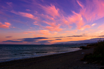 Fototapeta na wymiar Beach. Sunset on a stone beach in Estepona.