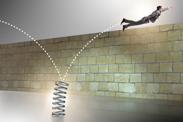 Businessman jumping from spring in business concept