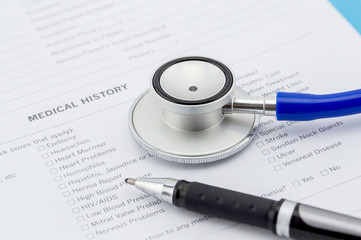 Medical questionnaire, stethoscope and pen
