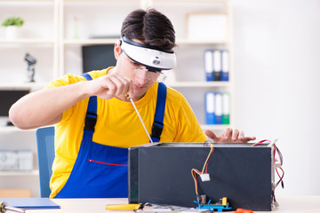 Computer repair technician repairing hardware
