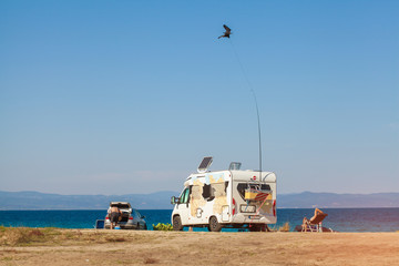 RV camping by the water on a Sunny day. Car with airbrushing on the beach near the sea.