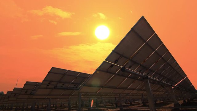 Solar power panels tracking sunrise with  morning warm sky time lapse