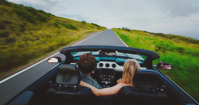 Lifestyle of couple driving on road trip in convertible