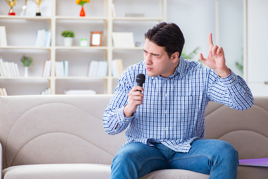 Funny man singing songs in karaoke at home