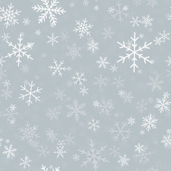 White snowflakes seamless pattern on light grey Christmas background. Chaotic scattered white snowflakes. Enchanting Christmas creative pattern. Vector illustration.