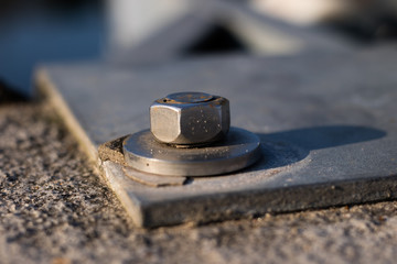 Nut and washer attached to the steel structure. Fixing of steel supports for concrete foundations.