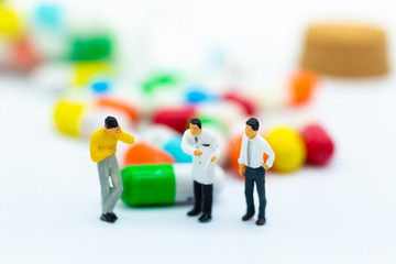Miniature people: Check your health with doctor. Image use for drug, pills, capsules ,Health and medicine concept.