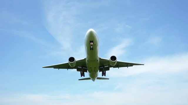Jet plane approaching landing across blue sky