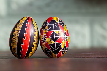 white organic eggs in tray and traditional painted easter eggs from Bucovina region, Romania