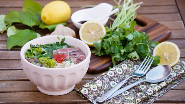 Pho soup -  Vietnamese noodle soup with broth, linguine-shaped rice noodles, cilantro and beef