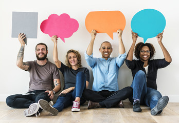 People carryng speech bubble icons