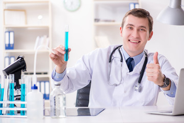 Male doctor looking at lab results in hospital