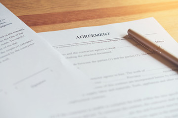 Obraz premium closeup of signing a documentation agreement and pen on the table.