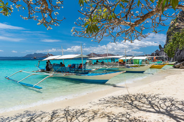 View of traditional boats at Coron Island beach, Philippines. Coron Island is a wedge-shaped limestone island in the province of Palawan.