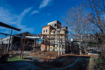 Fototapeta na wymiar Abandoned ruined reinforced concrete plant in Abkhazia